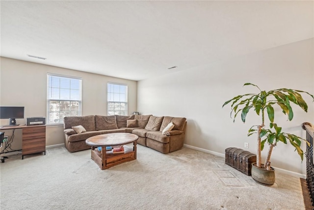 living room featuring visible vents, baseboards, and light carpet