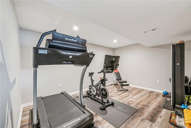 exercise room featuring recessed lighting, visible vents, baseboards, and wood finished floors