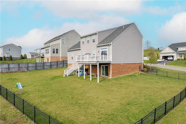 back of house featuring a lawn, a fenced backyard, stairs, a wooden deck, and a residential view