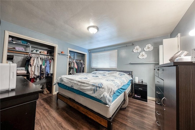 428 Brunner, Monroeville, PA 15146 - bedroom with a textured ceiling, baseboards, dark wood-style floors, and multiple closets