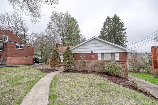 428 Brunner, Monroeville, PA 15146 - view of front of house featuring a front yard, brick siding, and a chimney