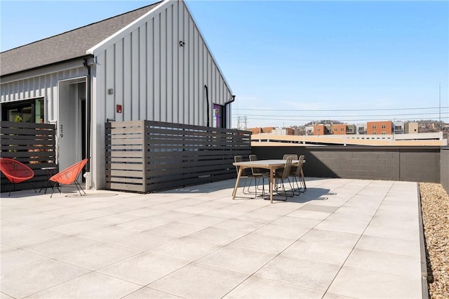 view of patio with outdoor dining space and fence