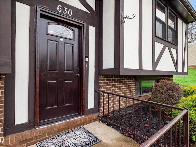 view of exterior entry with brick siding