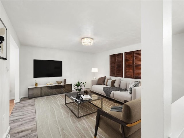 living room with baseboards and wood finished floors