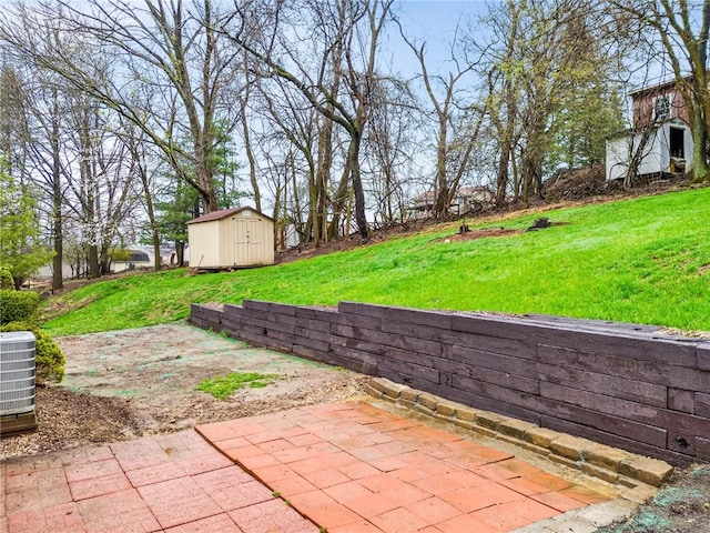 view of yard with a storage shed, cooling unit, a patio area, and an outdoor structure