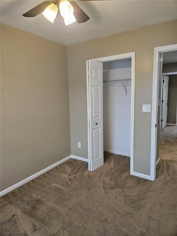 unfurnished bedroom featuring a closet, baseboards, carpet flooring, and ceiling fan