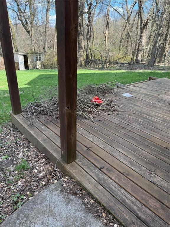 wooden deck with a yard and an outbuilding