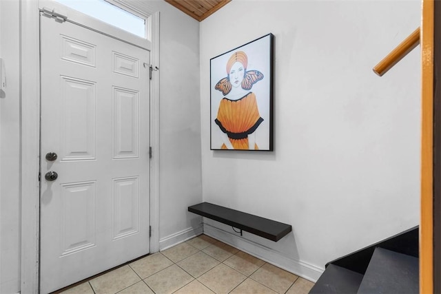 foyer featuring light tile patterned flooring and baseboards