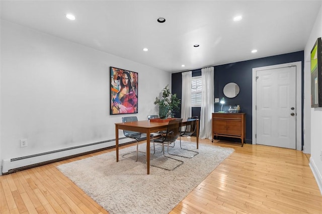 home office with light wood finished floors, a baseboard heating unit, and recessed lighting