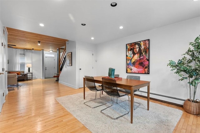 office space featuring light wood-style flooring, a baseboard heating unit, baseboards, and recessed lighting