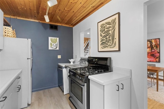 kitchen featuring light wood-type flooring, freestanding refrigerator, wood ceiling, visible vents, and stainless steel range with gas stovetop