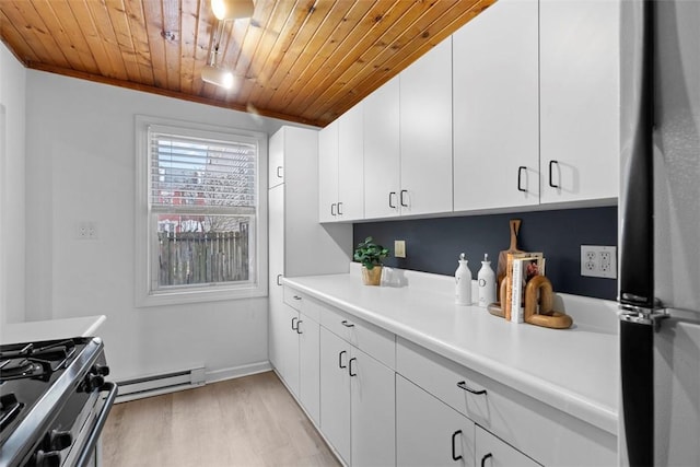 kitchen with light countertops, freestanding refrigerator, wooden ceiling, and a baseboard heating unit