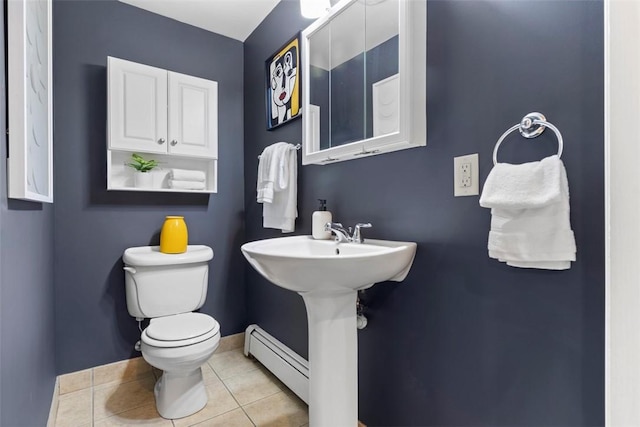 bathroom featuring toilet, a baseboard radiator, baseboards, and tile patterned floors