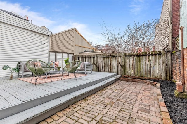 wooden terrace with a fenced backyard