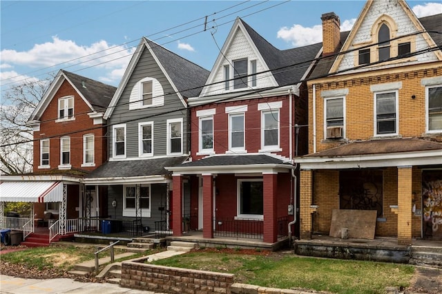 830 Adelaide St, Schenley Heights, PA 15219 - view of front facade with brick siding, a chimney, a shingled roof, and covered porch