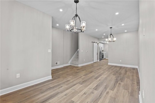 830 Adelaide St, Schenley Heights, PA 15219 - interior space with an inviting chandelier, recessed lighting, light wood-style flooring, a barn door, and visible vents