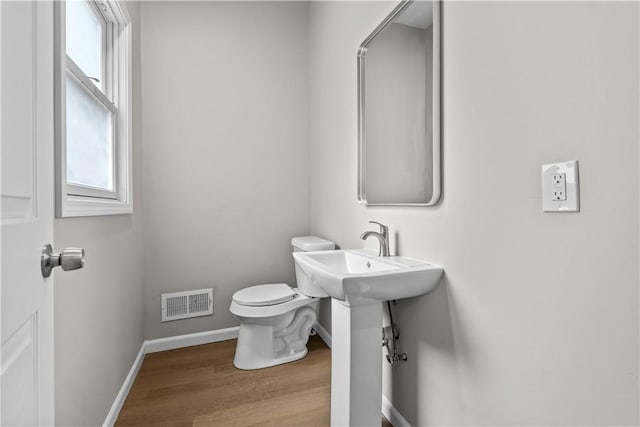 830 Adelaide St, Schenley Heights, PA 15219 - bathroom featuring visible vents, toilet, wood finished floors, and baseboards