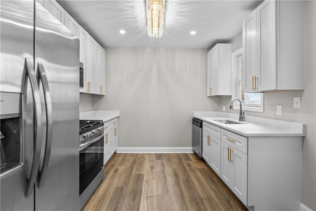830 Adelaide St, Schenley Heights, PA 15219 - kitchen featuring a notable chandelier, light countertops, appliances with stainless steel finishes, a sink, and wood finished floors