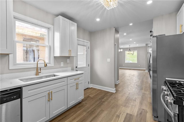 830 Adelaide St, Schenley Heights, PA 15219 - kitchen featuring stainless steel appliances, a sink, a chandelier, and wood finished floors
