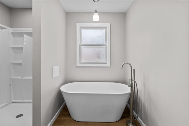 830 Adelaide St, Schenley Heights, PA 15219 - full bathroom featuring a freestanding bath, baseboards, walk in shower, and wood finished floors