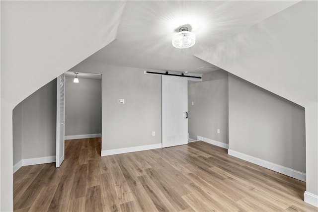 830 Adelaide St, Schenley Heights, PA 15219 - bonus room with a barn door, baseboards, and wood finished floors