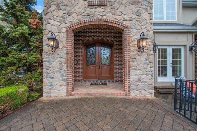 doorway to property with french doors and stone siding