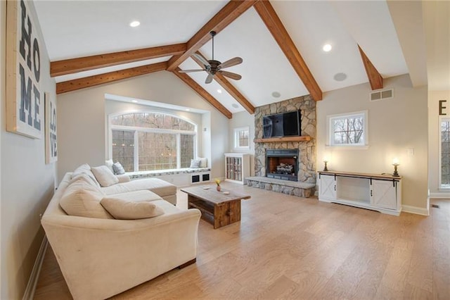 living room with ceiling fan, baseboards, visible vents, and wood finished floors