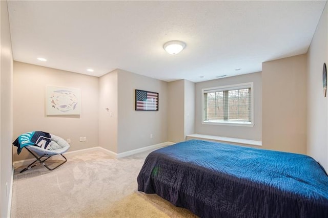 bedroom with light colored carpet and baseboards