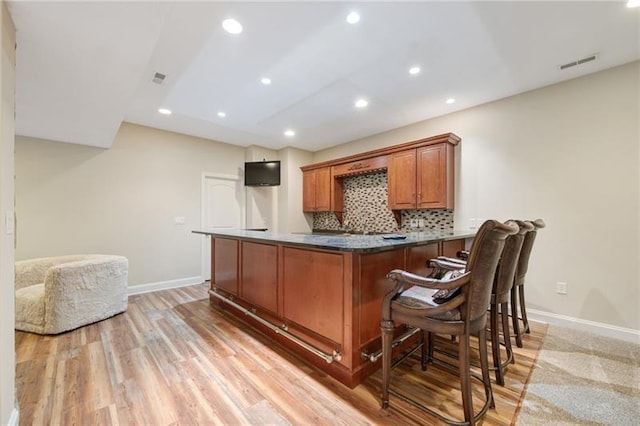 bar featuring tasteful backsplash, light wood-type flooring, baseboards, recessed lighting, and visible vents