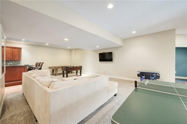 living area featuring recessed lighting, light colored carpet, and baseboards