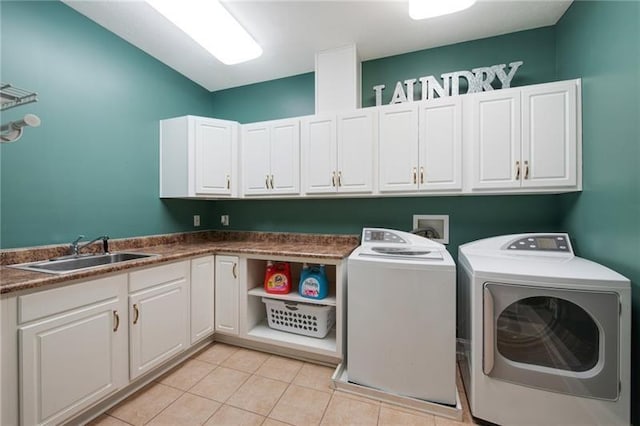 laundry room featuring washer and dryer, light tile patterned flooring, a sink, and cabinet space