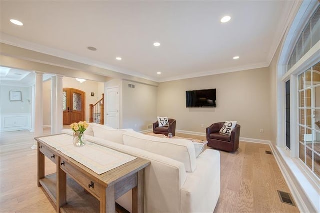 living room featuring recessed lighting, light wood finished floors, visible vents, and ornamental molding