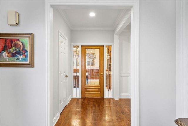 interior space with ornamental molding and wood finished floors