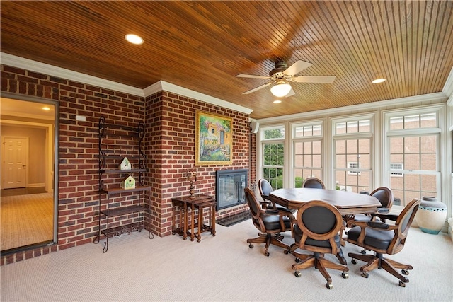 dining area with brick wall, a fireplace, crown molding, carpet floors, and wooden ceiling