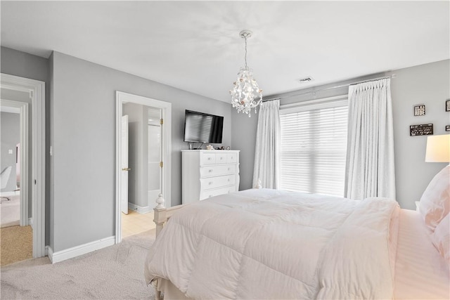 bedroom with visible vents, baseboards, a notable chandelier, connected bathroom, and light carpet