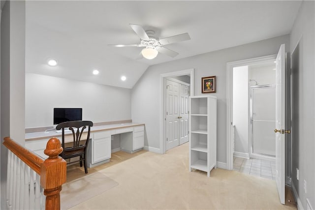 home office with light colored carpet, baseboards, a ceiling fan, and vaulted ceiling
