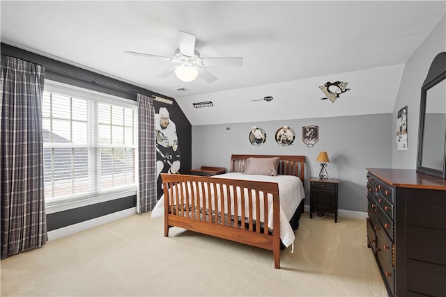 bedroom with baseboards, vaulted ceiling, and light carpet