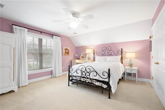 bedroom with baseboards, a ceiling fan, vaulted ceiling, and light carpet