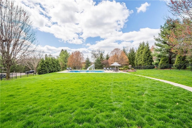 view of property's community with a patio, a swimming pool, fence, and a lawn