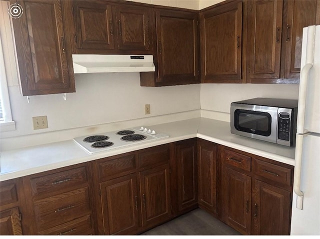 kitchen with dark brown cabinets, light countertops, white appliances, and under cabinet range hood