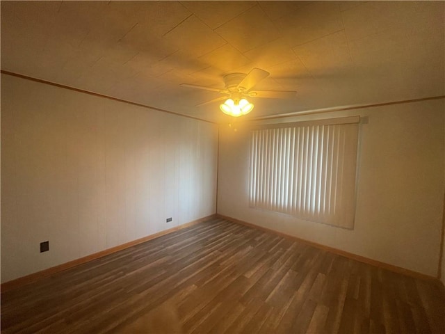 unfurnished room featuring baseboards, a ceiling fan, ornamental molding, and wood finished floors