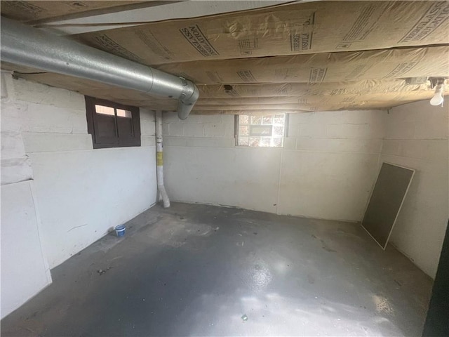 below grade area featuring plenty of natural light and concrete block wall