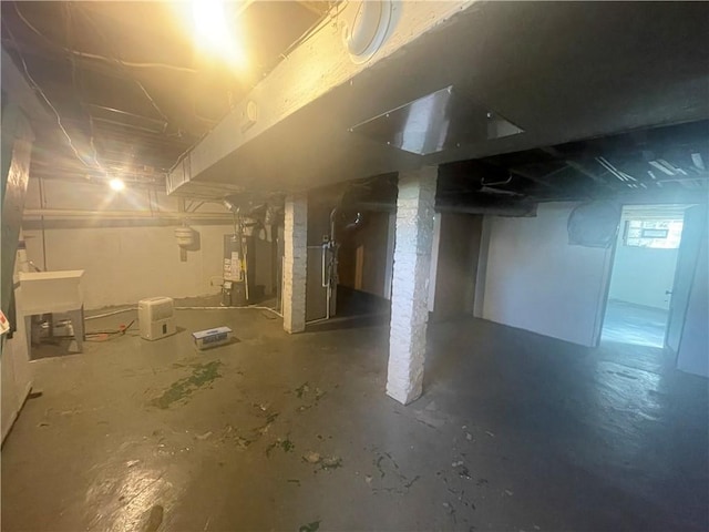 below grade area with a sink and gas water heater