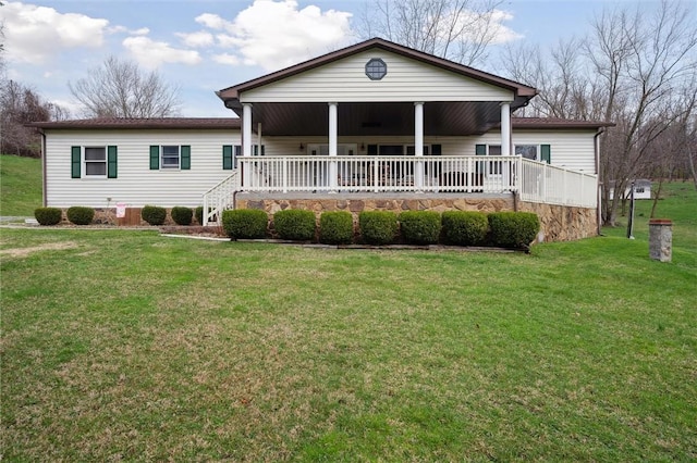 rear view of property with a yard and a porch