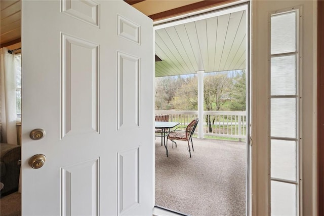 doorway to outside with carpet flooring