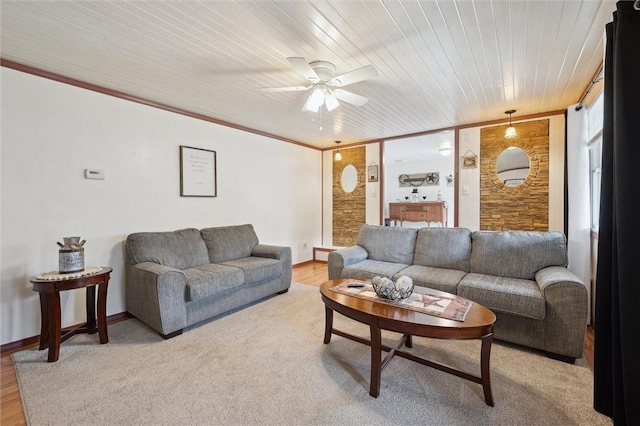 living area featuring crown molding, light wood-style flooring, a ceiling fan, wooden ceiling, and baseboards