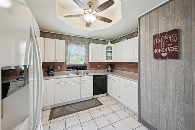 kitchen featuring ceiling fan, white fridge with ice dispenser, light tile patterned floors, black dishwasher, and a sink