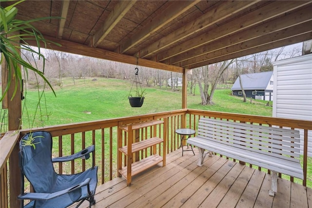 wooden terrace featuring a lawn
