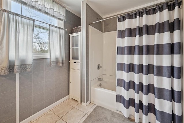 bathroom featuring tile walls, shower / tub combo with curtain, and tile patterned flooring