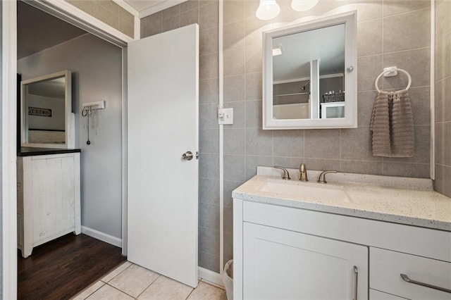 bathroom with tile patterned floors, vanity, and tile walls